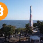 Fotografía del obelisco de Santo Domingo con el logo de bitcoin.